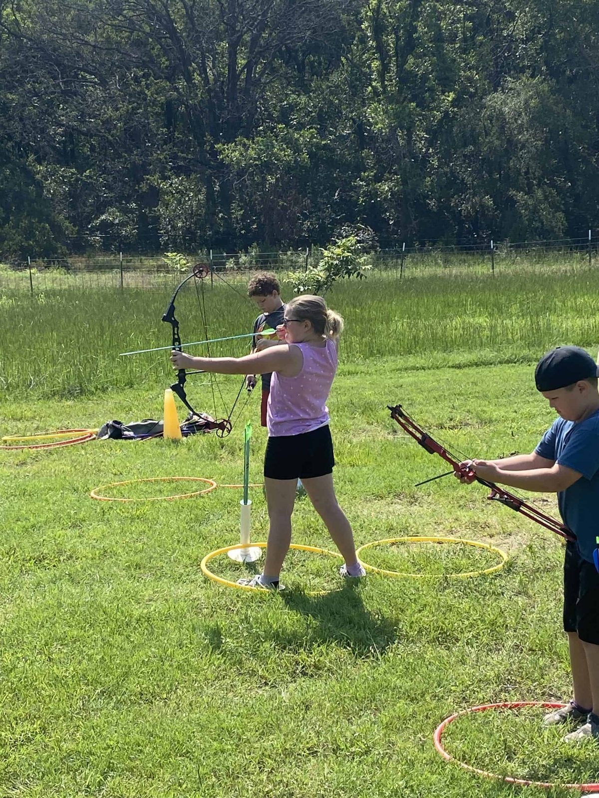 Selwyn students shooting archery in the field on campus